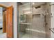Updated bathroom featuring a large shower with a built-in bench and glass door at 3179 S Indiana St, Lakewood, CO 80228