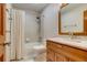 Clean and bright bathroom featuring tiled bath, toilet and granite vanity at 3179 S Indiana St, Lakewood, CO 80228