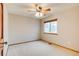 Bright bedroom features plush carpet, a window, and a modern ceiling fan at 3179 S Indiana St, Lakewood, CO 80228