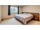 Bright bedroom with a queen size bed and a large window at 3179 S Indiana St, Lakewood, CO 80228