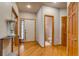 Inviting entryway with hardwood floors, white walls, and natural wood trim welcomes you home at 3179 S Indiana St, Lakewood, CO 80228