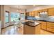 Sunlit kitchen with granite countertops, stainless steel appliances, and adjacent breakfast nook at 3179 S Indiana St, Lakewood, CO 80228
