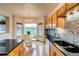 Bright eat in kitchen with wood floors, granite countertops, and stainless steel appliances at 3179 S Indiana St, Lakewood, CO 80228