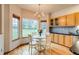 Eat in kitchen with wood floors, a breakfast table, and an abundance of natural light at 3179 S Indiana St, Lakewood, CO 80228