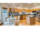 Eat in Kitchen with wood floors, an island, modern appliances, and stylish light fixture at 3179 S Indiana St, Lakewood, CO 80228