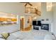Bright living room featuring a fireplace, ceiling fan, and an open floor plan at 3179 S Indiana St, Lakewood, CO 80228