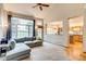 Spacious living room with large windows and a comfortable gray sectional sofa at 3179 S Indiana St, Lakewood, CO 80228