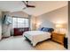 Spacious main bedroom with a large window, stylish ceiling fan and vaulted ceilings at 3179 S Indiana St, Lakewood, CO 80228