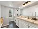 Well-lit bathroom featuring a marble shower, large vanity, and dark tile floors at 805 5Th St, Fort Lupton, CO 80621