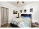 Cozy bedroom featuring dark floors, queen bed, TV and decorative wall art for relaxing at 805 5Th St, Fort Lupton, CO 80621