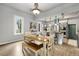 Eat-in kitchen with a wooden dining table, breakfast bar, stainless steel appliances, and natural light at 805 5Th St, Fort Lupton, CO 80621