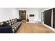 Finished basement with laminated floors, a plaid sofa and entertainment options at 805 5Th St, Fort Lupton, CO 80621