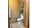 Bathroom featuring a toilet, wood cabinet, neutral walls, and decorative accessories at 17046 Wellington Dr, Parker, CO 80134