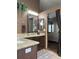 Bathroom featuring dual sinks, granite countertops, dark wood cabinets, and Primary bedroom view at 17046 Wellington Dr, Parker, CO 80134