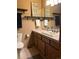 Charming bathroom with light wood cabinets and a unique wall decor at 17046 Wellington Dr, Parker, CO 80134