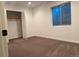 Bedroom features neutral carpet, white walls and trim, and a large window for plenty of light at 17046 Wellington Dr, Parker, CO 80134