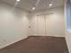 The bedroom features neutral carpet, white walls and trim, and a closet with bifold doors at 17046 Wellington Dr, Parker, CO 80134