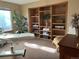 Bright bedroom featuring a massage table, open shelving, and a neutral color palette at 17046 Wellington Dr, Parker, CO 80134