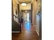 Inviting foyer with hardwood floors, decorative lighting, and a staircase leading to the upper level at 17046 Wellington Dr, Parker, CO 80134
