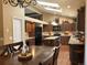 Spacious eat-in kitchen with granite countertops, stainless steel appliances, wood floors, and a center island at 17046 Wellington Dr, Parker, CO 80134