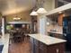 Open-concept kitchen with granite countertops, a center island, and views of the living and dining areas at 17046 Wellington Dr, Parker, CO 80134