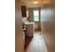 The laundry room has wood plank flooring and a window for plenty of natural light at 17046 Wellington Dr, Parker, CO 80134