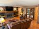 Comfortable living room featuring a fireplace, built-in shelving, and comfortable leather furniture at 17046 Wellington Dr, Parker, CO 80134