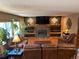 Cozy living room with a fireplace, built-in shelving, and comfortable leather furniture at 17046 Wellington Dr, Parker, CO 80134