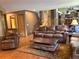 Open concept living room with leather furniture, wood floors, and a coffee table with storage at 17046 Wellington Dr, Parker, CO 80134