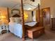 Spacious main bedroom featuring a four-poster bed and plenty of natural light at 17046 Wellington Dr, Parker, CO 80134