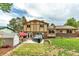 Expansive backyard featuring a patio, hot tub, lush lawn, shed, and mature landscaping, perfect for outdoor living at 6441 W 73Rd Pl, Arvada, CO 80003