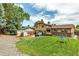 Wide backyard featuring well maintained lawn, patio, swing set, and home exterior at 6441 W 73Rd Pl, Arvada, CO 80003