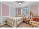 Charming bedroom with floral bedding, colorful walls, and cozy armchair seating at 6441 W 73Rd Pl, Arvada, CO 80003