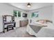 Bright bedroom with carpet, vanity, neutral walls, and windows looking out to greenery at 6441 W 73Rd Pl, Arvada, CO 80003