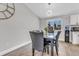 Dining room featuring a modern chandelier, a view to the front yard, and neutral paint at 6441 W 73Rd Pl, Arvada, CO 80003