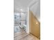 Laundry room area with stacked washer and dryer and tiled floors near stairs at 6441 W 73Rd Pl, Arvada, CO 80003
