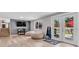 Finished basement living room with doors to the patio and laminate floors at 6441 W 73Rd Pl, Arvada, CO 80003