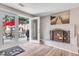 Living room featuring a fireplace and doors to a large back patio at 6441 W 73Rd Pl, Arvada, CO 80003