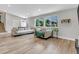 Bright living room with new floors, and comfortable seating, and a view of the front yard at 6441 W 73Rd Pl, Arvada, CO 80003
