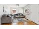 Cozy living room features two sofas, a decorative rug, and natural light from large window at 3258 Niagara St, Denver, CO 80207