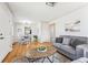 Bright living room with hardwood floors, modern decor, and seamless flow into the dining area at 3258 Niagara St, Denver, CO 80207