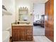 Bathroom vanity with granite countertops, wood cabinets and a view to the bedroom at 715 S Alton Way # 5D, Denver, CO 80247