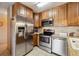 Well-equipped kitchen featuring stainless steel appliances, tile floors, and ample cabinet space at 715 S Alton Way # 5D, Denver, CO 80247