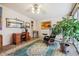 Bright living room featuring a desk area, ceiling fan, carpeted floors and a large plant at 715 S Alton Way # 5D, Denver, CO 80247