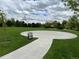 Community basketball court with hoops and a trash receptacle at 11947 Riverstone Cir # 7F, Henderson, CO 80640