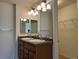 Bathroom featuring double sink vanity, large mirror, and walk-in closet at 11947 Riverstone Cir # 7F, Henderson, CO 80640
