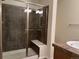 Bathroom featuring a shower with a glass door and neutral tile at 11947 Riverstone Cir # 7F, Henderson, CO 80640