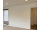 Bright bedroom with neutral walls, plush carpeting, closet and a window with decorative curtains at 11947 Riverstone Cir # 7F, Henderson, CO 80640