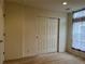 Bedroom with sliding closet door, neutral carpet and natural light at 11947 Riverstone Cir # 7F, Henderson, CO 80640