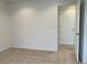 Bedroom with neutral carpet, light walls, and a doorway to an adjacent room at 11947 Riverstone Cir # 7F, Henderson, CO 80640